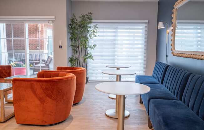 a living room with couches tables and chairs and a mirror