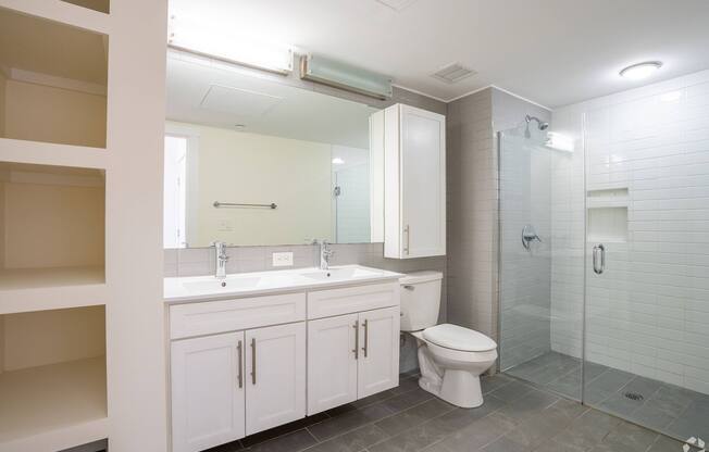 A white bathroom with a toilet, sink, and shower at 603 Concord Apartments, Cambridge