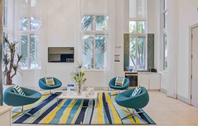 Modern resident lounge with blue seating inside a Miami high rise apartment building.