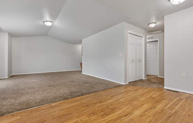 A room with wooden floors and white walls.
