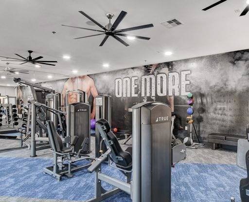 A gym with a variety of equipment including a rowing machine.