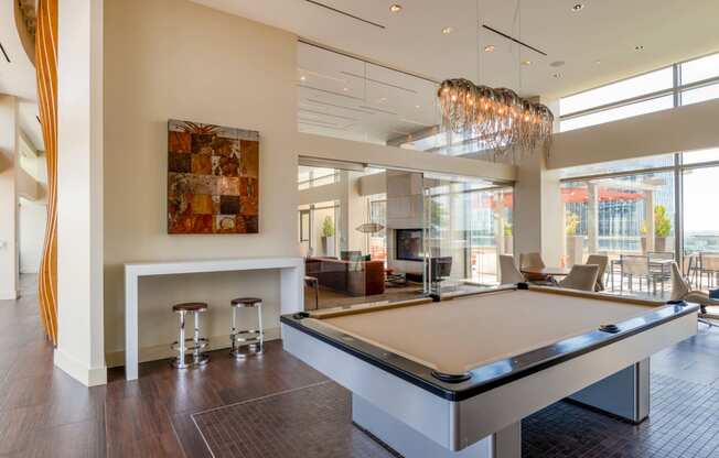 a game room with a pool table and a bar