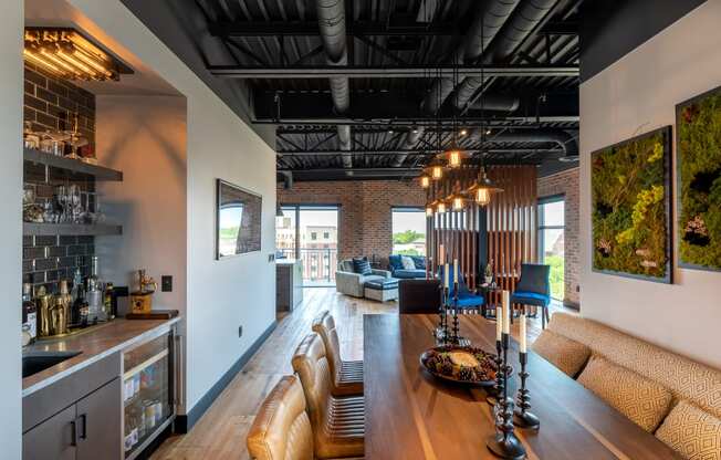 the kitchen and living room of a house with a large wooden table and chairs