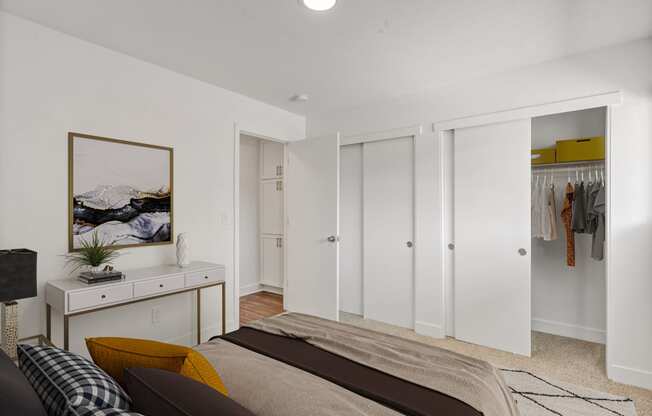 a bedroom with white walls and white closets