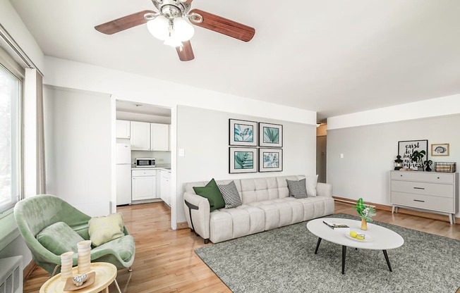 a living room with a white couch and a green chair
