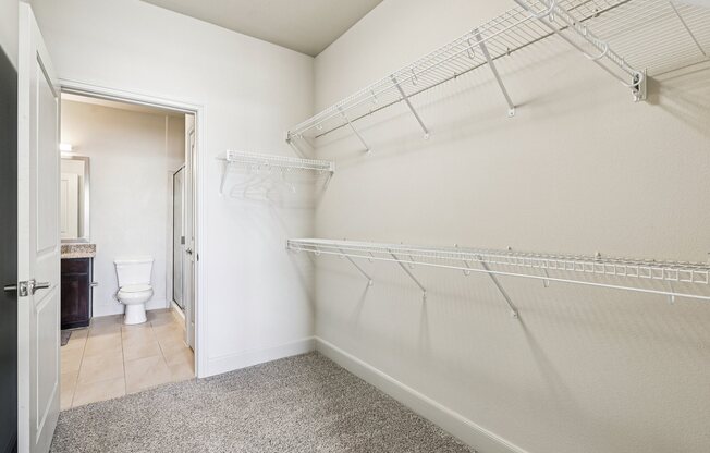 A white wall with a metal rack on it.