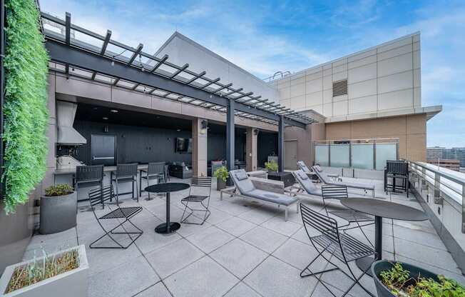 A patio with a table and chairs is surrounded by a building.