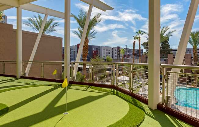 a putting green on a balcony with a pool at The Rays at Vegas Towers Apartments, Las Vegas, 89119