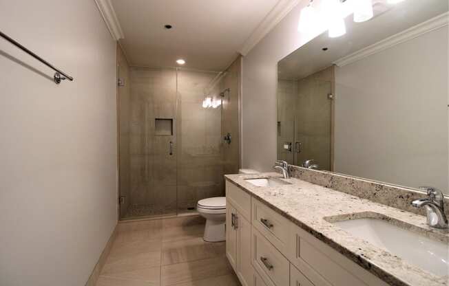 A bathroom with a toilet, sink, and shower.