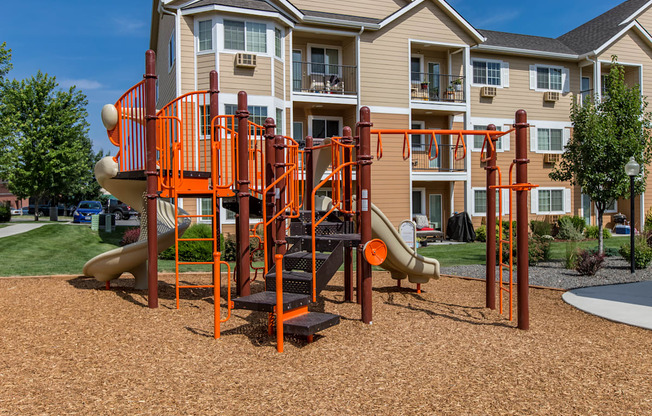an orange playground in front of an apartment building  at Quail Springs, Washington, 99353