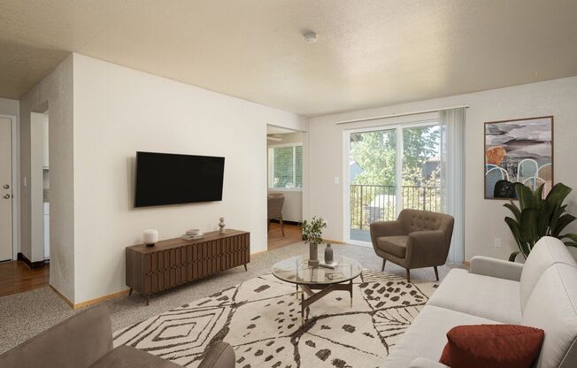 A living room with a white couch, a brown side table, and a flat screen TV mounted on the wall.