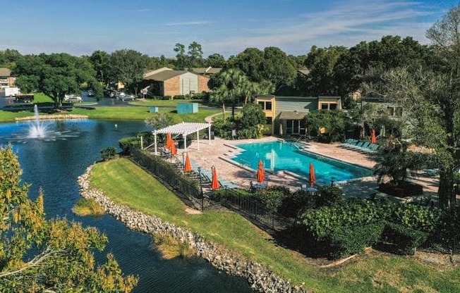 an aerial view of a swimming pool and a lake