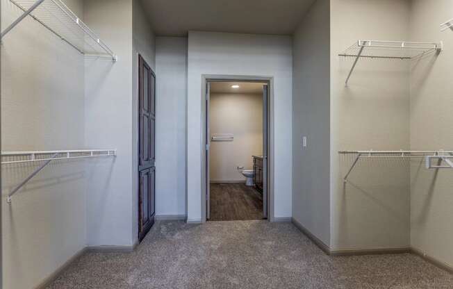 a walk in closet in a bedroom plus den unit at the casey, 2100 delgan