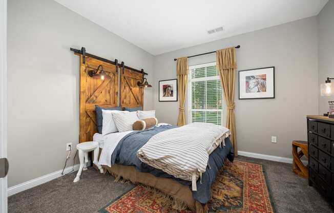 a bedroom with a bed and a window with a barn door