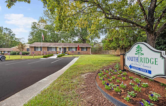 A sign for Southridge Nursing Home is in the foreground of a parking lot.