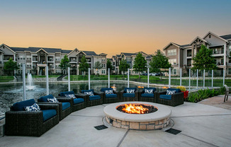 Cozy Firepit and Outdoor Lounge Seating by Lake at Houston Apartment Complex