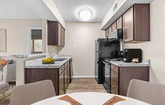 our apartments have a kitchen and dining room with a table and chairs