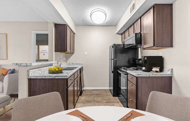 our apartments have a kitchen and dining room with a table and chairs