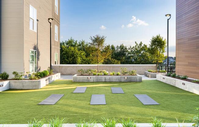 Outdoor yoga and wellness lawn designed for movement and relaxation at Modera LoSo.