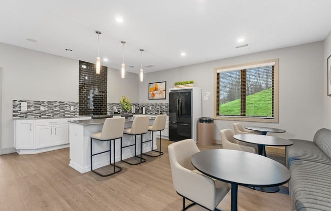 A modern kitchen with a bar area and a dining table.