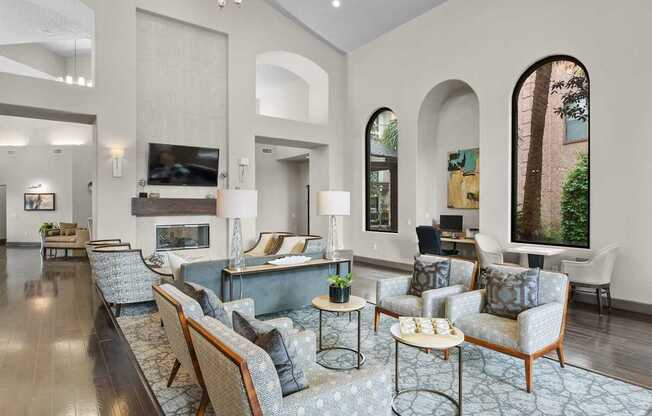 A living room with a grey carpet and furniture.