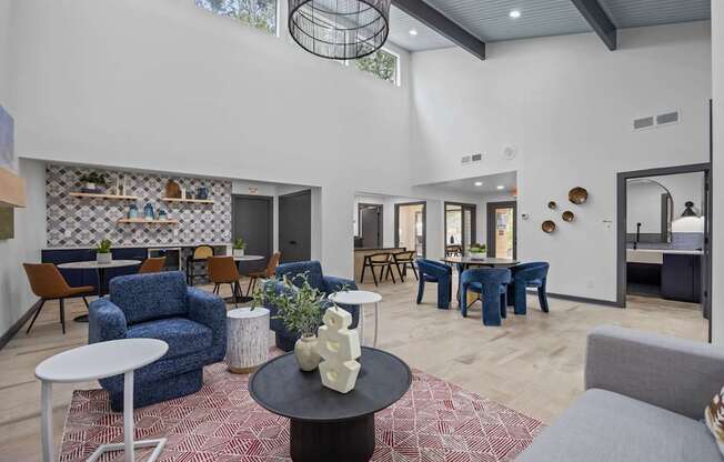 A modern living room with a variety of furniture and decorative items.