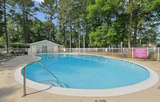 A large round pool with setting around.