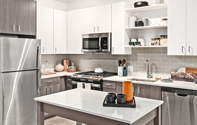 Beautifully equipped kitchens with stunning white cabinetry with chrome pulls and stainless steel appliances