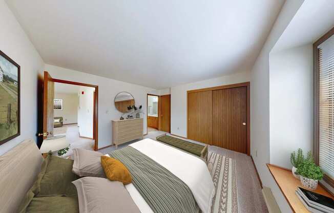 A bedroom with a bed, couch, and a painting on the wall.