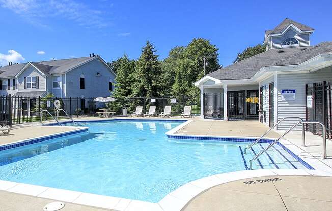 Fenced-In Outdoor Pool with Lounge Furniture