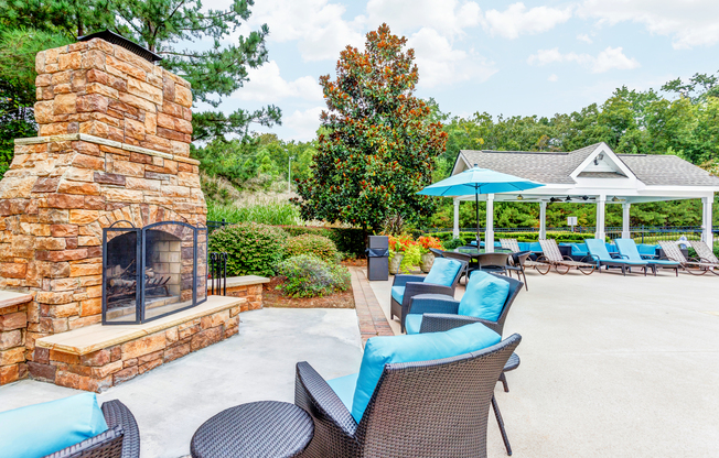 View of Pool Area, Showing Fireplace, Outdoor Furniture, and Cabana at Summer Park Apartments