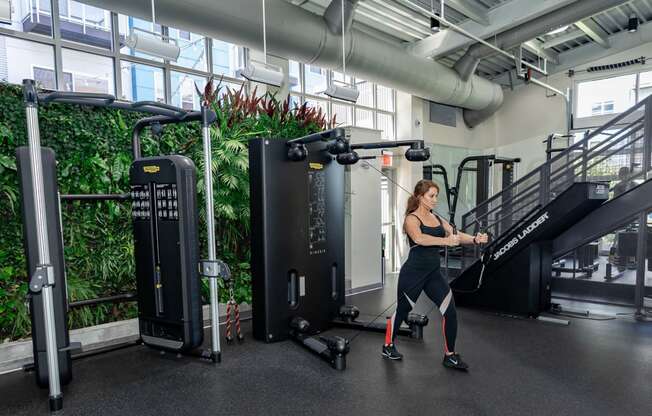 a woman is running on a treadmill in a gym