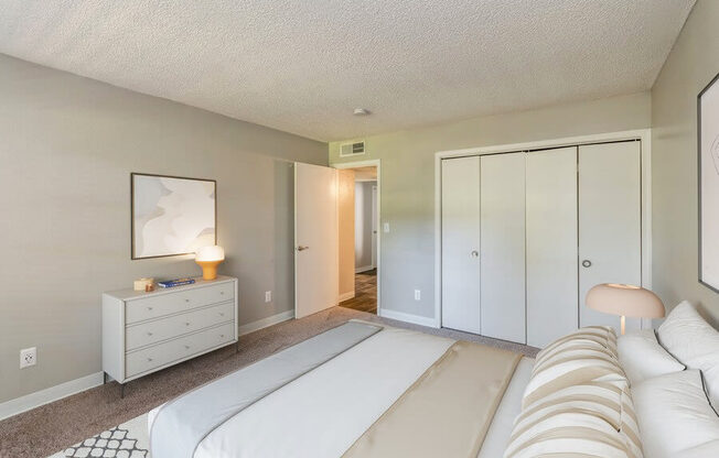 Model Bedroom with Carpet and Closet at Indigo Park Apartments in Albuquerque, NM.