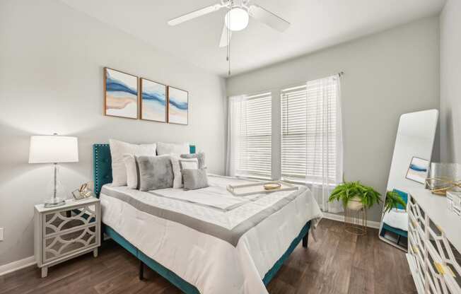 a bedroom with a large bed and a ceiling fan