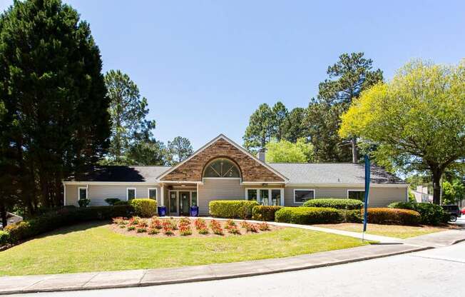 A house with a white front yard and a blue mailbox.