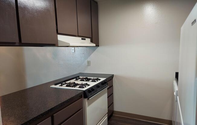 a stove top oven sitting inside of a kitchen