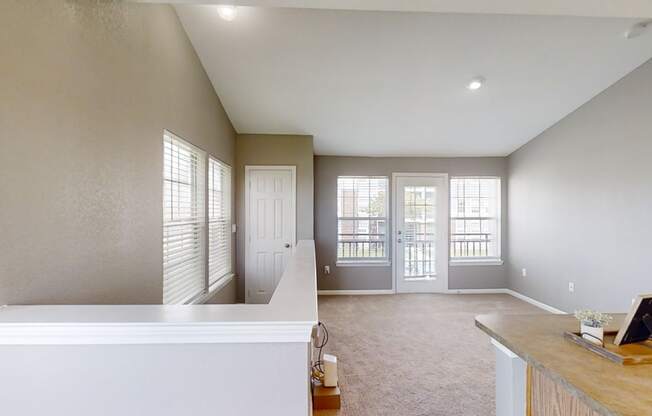 Large living room with a staircase and a door to a balcony