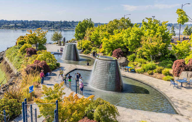 A group of people are standing in front of a water feature at Spyglass Hill Apartments, Bremerton, 98337