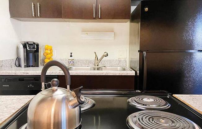 a kitchen with a stove and a kettle on the stove