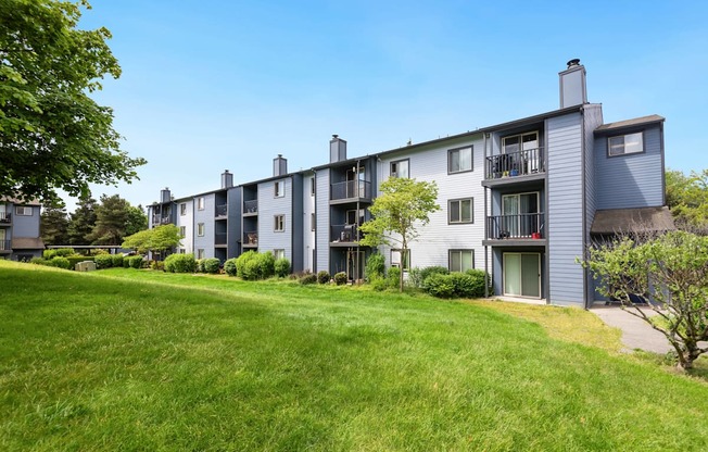 exterior view of apartment buildings on a sunny day at Eagles Landing Apartments, Everett, 98204