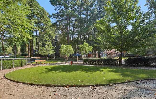 A park with a green lawn and trees.