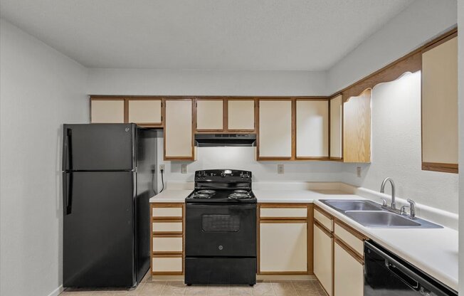 a kitchen with a stove refrigerator and sinkat Millcreek Woods Apartments, Olathe