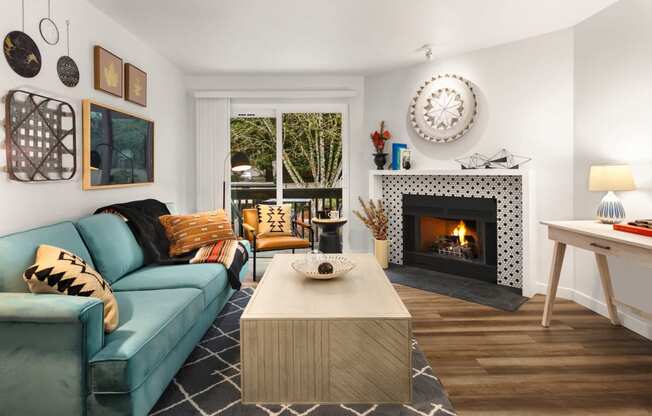 a living room with a blue couch and a fireplace