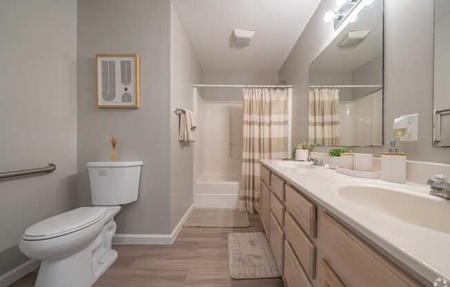 the preserve at ballantyne commons apartment bathroom with toilet sink and mirror