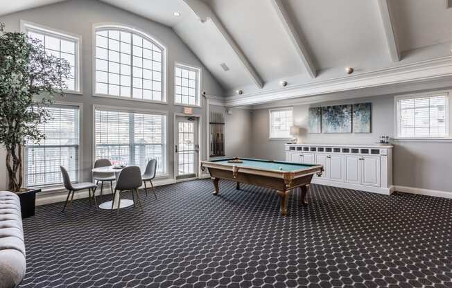 a recreation room with a pool table and a bar