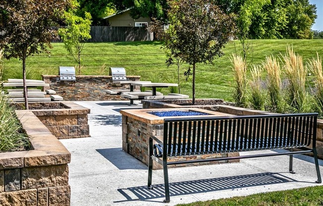 a park with benches and trees and a fountain