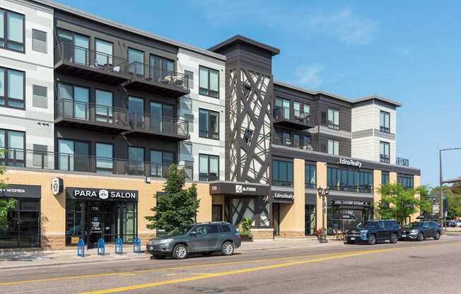 A street view of a building with a car parked in front.