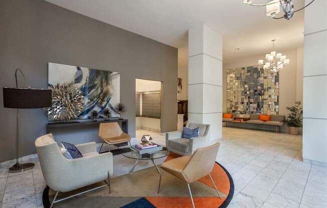 A living room with a grey couch and a white chair.