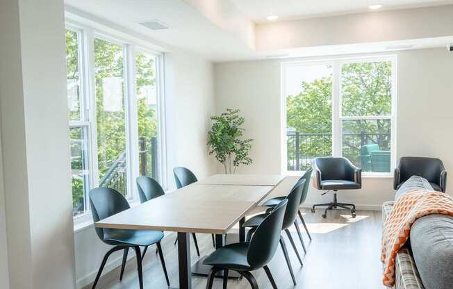 A conference room with a long table and chairs.