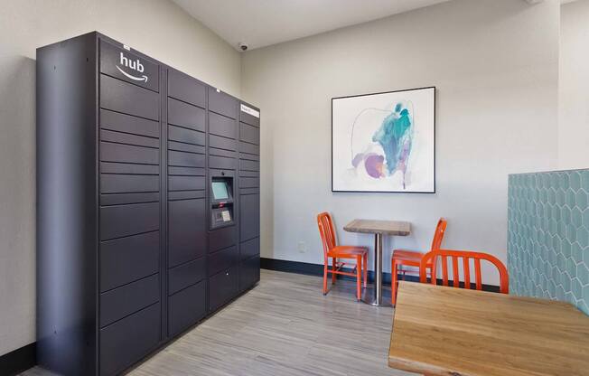 A room with a black locker and a wooden table.